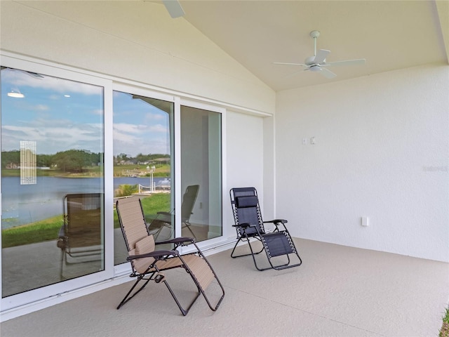 sunroom / solarium featuring ceiling fan, a water view, and lofted ceiling