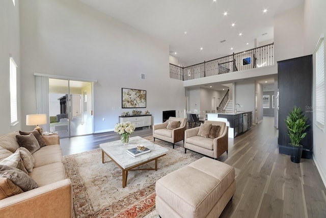 living room with a high ceiling and hardwood / wood-style flooring