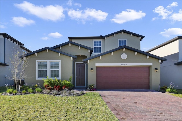 front of property with a front yard and a garage