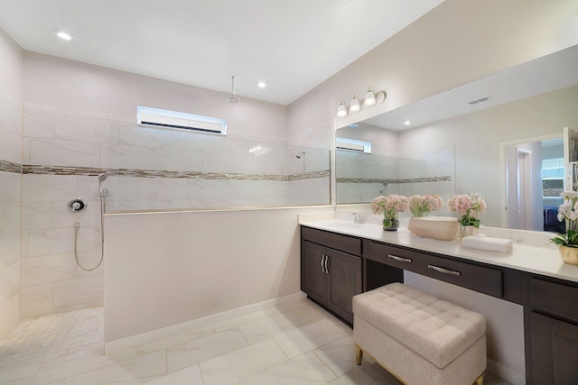 bathroom featuring vanity and tiled shower