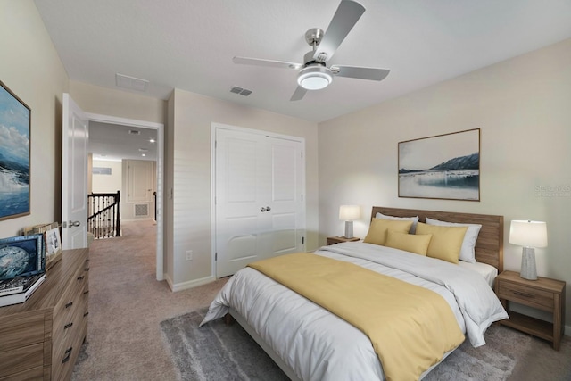 carpeted bedroom featuring ceiling fan and a closet