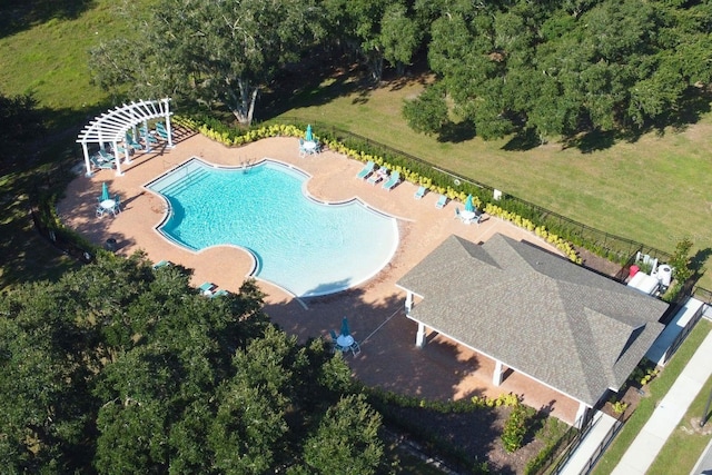 view of swimming pool featuring a patio and a lawn