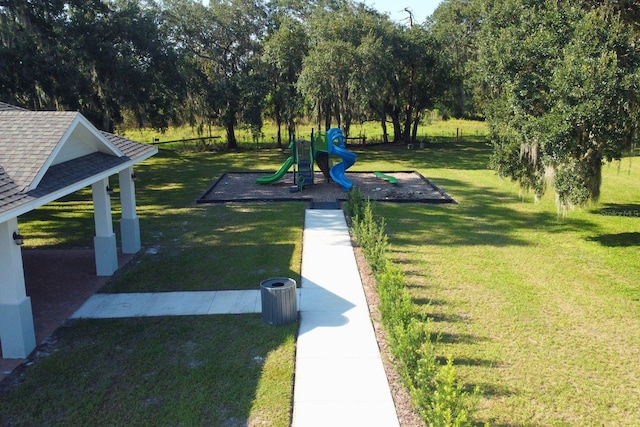 view of community featuring a playground and a yard