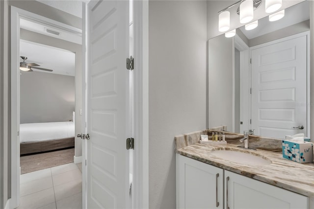 bathroom with tile flooring, vanity with extensive cabinet space, and ceiling fan