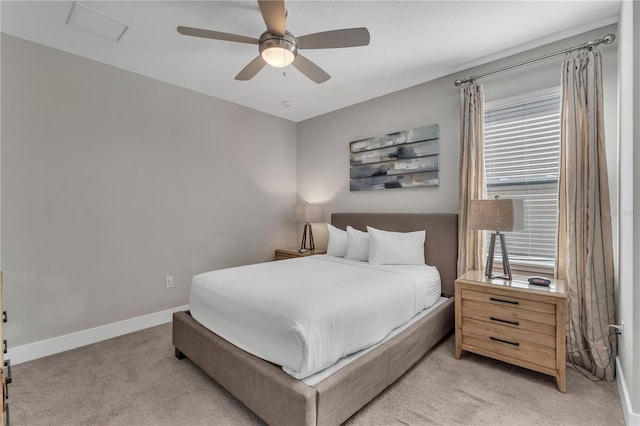 bedroom featuring light colored carpet and ceiling fan