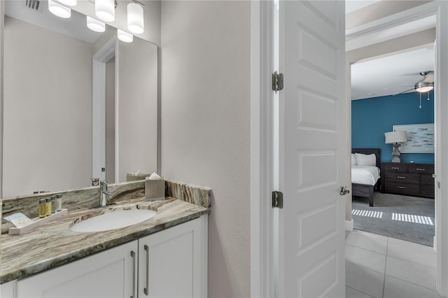 bathroom with ceiling fan, tile floors, and vanity