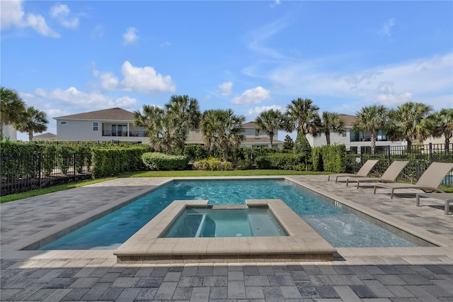 view of pool with a patio area and an in ground hot tub