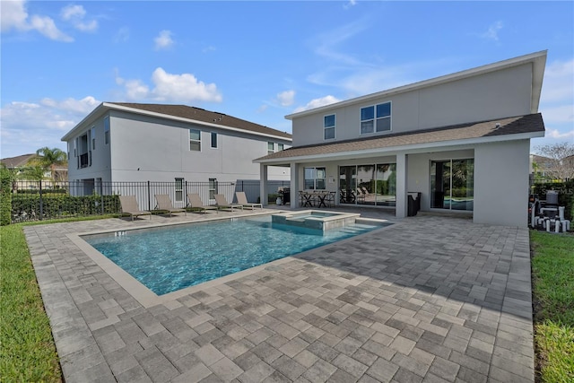 view of swimming pool with a patio area and an in ground hot tub