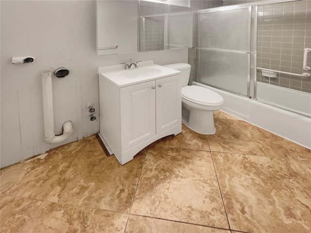 full bathroom with enclosed tub / shower combo, toilet, large vanity, and tile floors