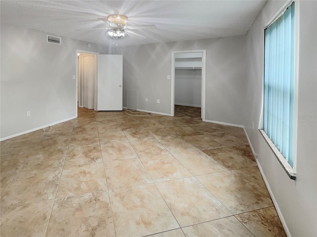 tiled spare room with a wealth of natural light