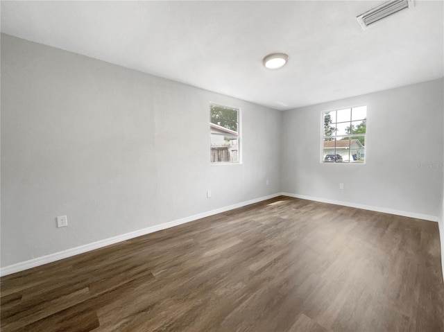 spare room with dark hardwood / wood-style floors