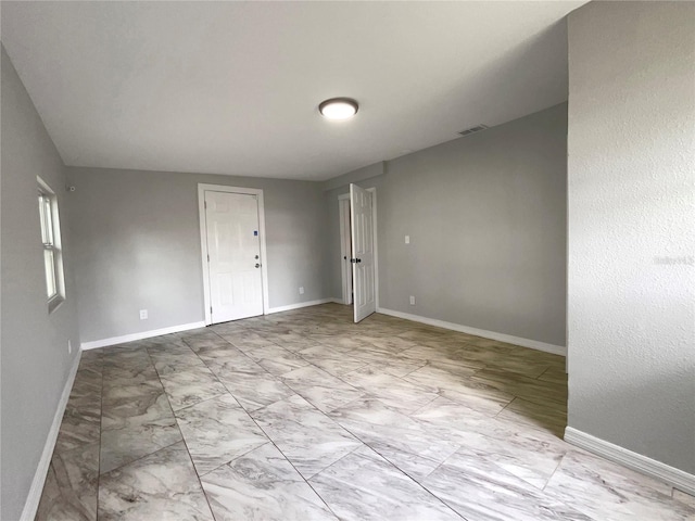 4011 Mesa Ave, Sarasota, FL 34233 - unfurnished room featuring marble look tiles and baseboards