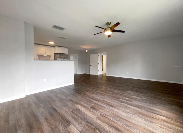 4011 Mesa Ave, Sarasota, FL 34233 - unfurnished living room with ceiling fan, baseboards, and dark wood-style flooring