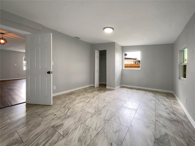 4011 Mesa Ave, Sarasota, FL 34233 - empty room with light marble finish flooring and baseboards