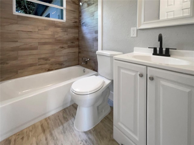 4011 Mesa Ave, Sarasota, FL 34233 - bathroom featuring wood finished floors, vanity, toilet,  shower combination, and a textured wall