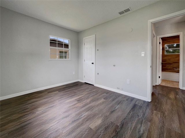 4011 Mesa Ave, Sarasota, FL 34233 - spare room featuring dark wood-type flooring, baseboards, and a textured ceiling