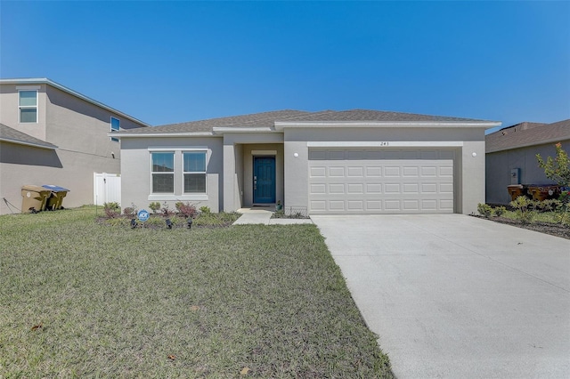 view of front of property with a front yard and a garage