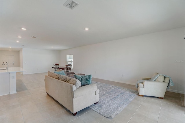 living room with sink and light tile floors