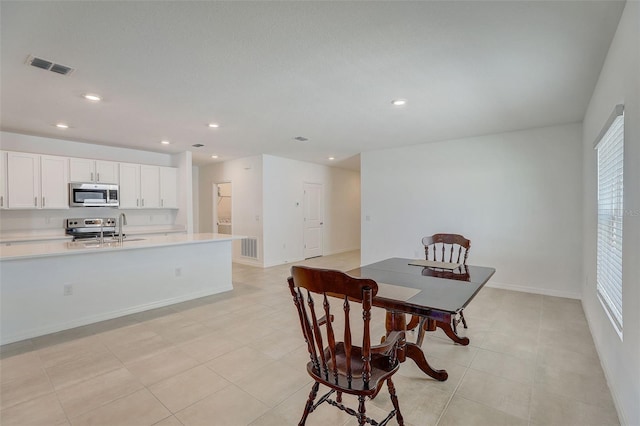 dining room with sink and light tile flooring