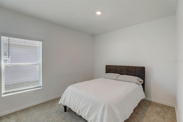 carpeted bedroom featuring multiple windows