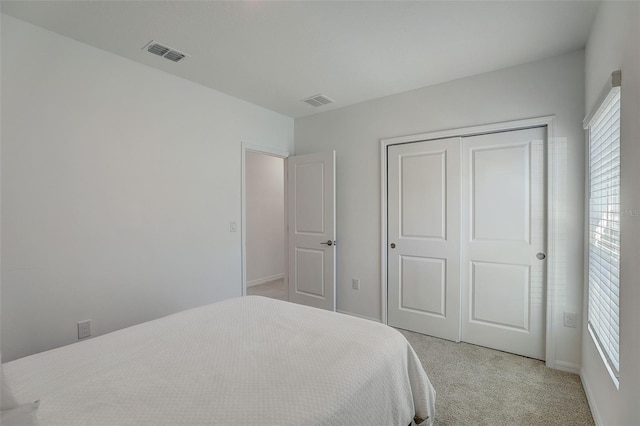 carpeted bedroom with a closet