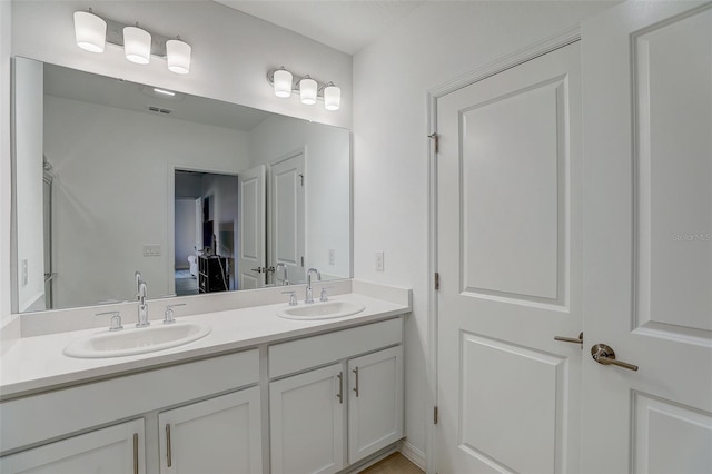 bathroom featuring double sink and vanity with extensive cabinet space