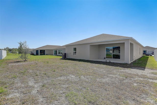 rear view of property with a lawn and a patio area