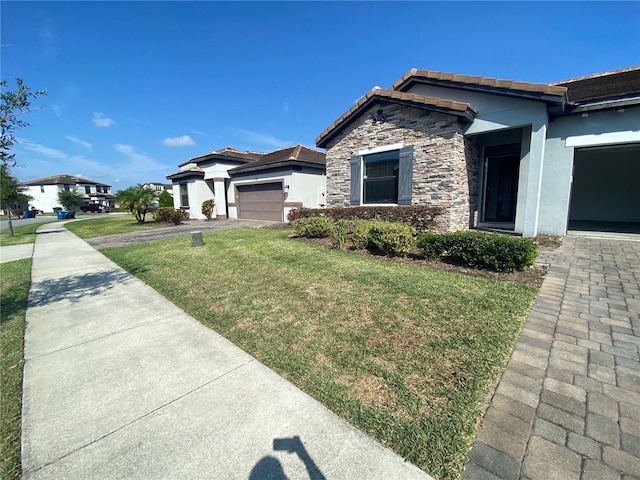 view of front of home with a front yard and a garage