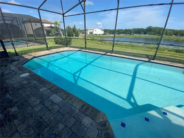 view of swimming pool with a lanai and a yard