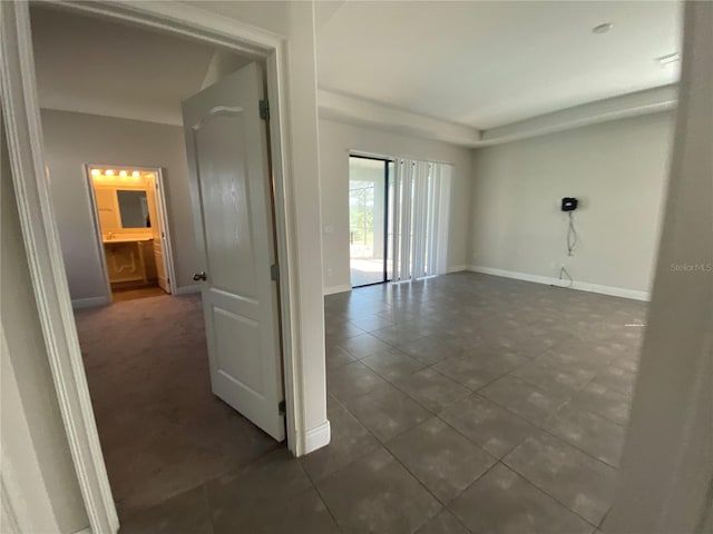 empty room featuring dark tile flooring