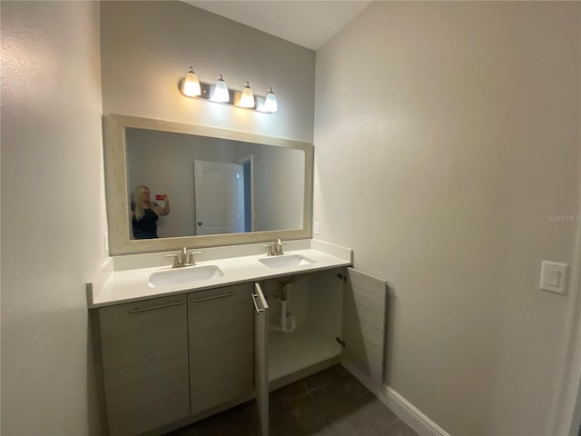 bathroom featuring tile floors, double sink, and vanity with extensive cabinet space