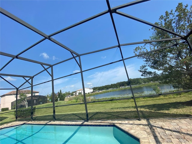 view of swimming pool featuring a water view, a yard, and a lanai