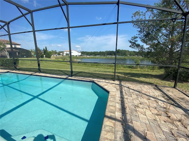 view of pool featuring a water view, a lanai, and a yard