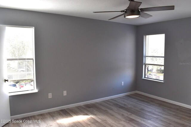 empty room featuring hardwood / wood-style flooring and ceiling fan