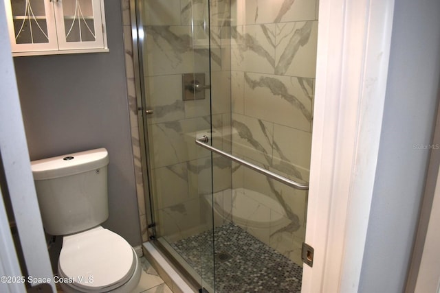 bathroom with an enclosed shower and toilet