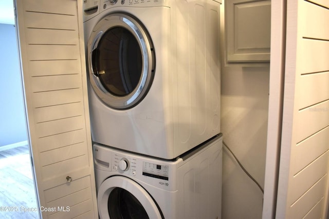 laundry area with stacked washing maching and dryer