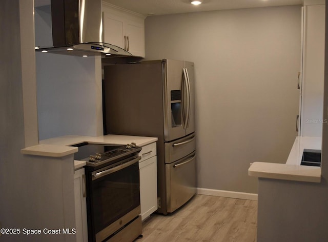 kitchen featuring light hardwood / wood-style flooring, ventilation hood, stainless steel appliances, and white cabinets