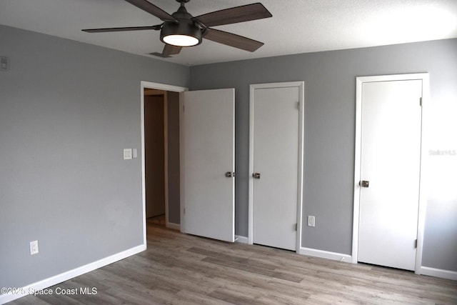 unfurnished bedroom with light hardwood / wood-style flooring and ceiling fan