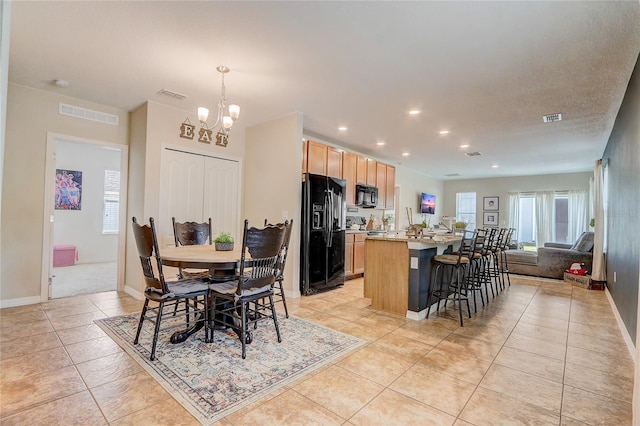 dining room featuring an inviting chandelier and light tile floors