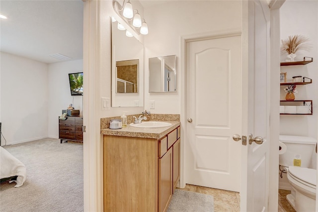 bathroom with toilet and vanity