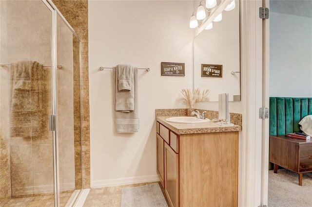 bathroom featuring tile floors, vanity, and walk in shower