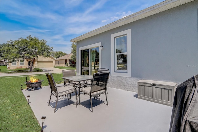 view of patio with an outdoor fire pit