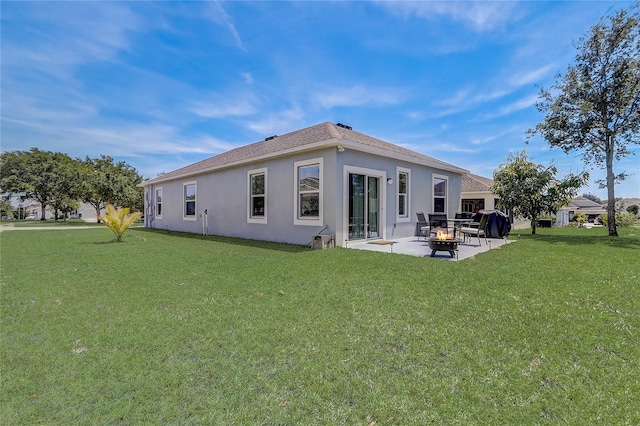 back of house featuring a patio area and a yard