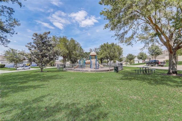 view of home's community with a lawn and a playground