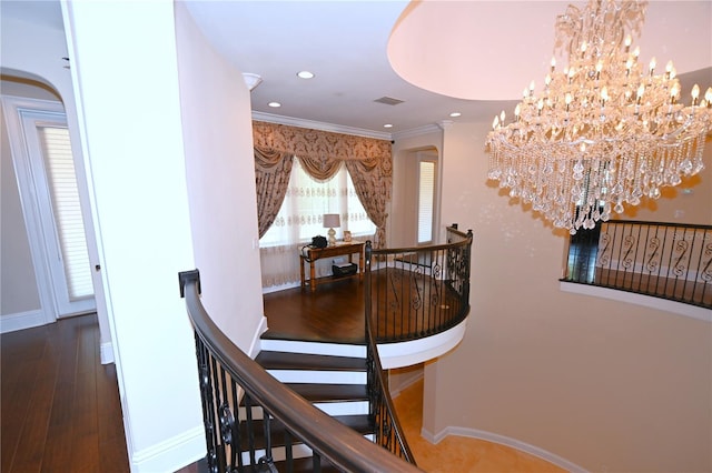 interior space featuring a healthy amount of sunlight, dark hardwood / wood-style floors, and a notable chandelier