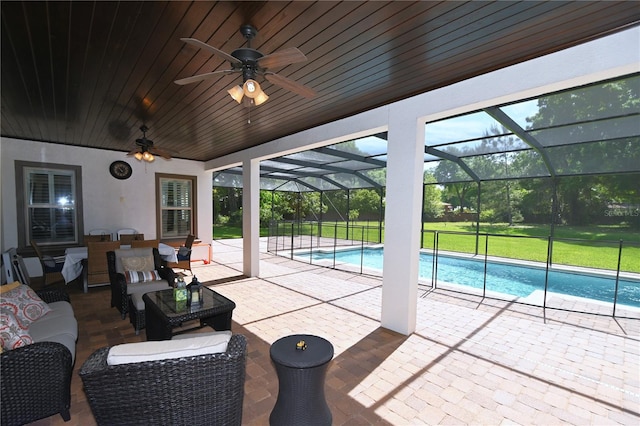 view of swimming pool featuring a patio, a lanai, and ceiling fan