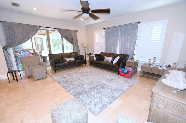 tiled living room with ceiling fan