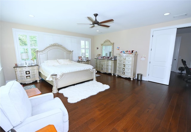 bedroom featuring dark wood-type flooring, ceiling fan, and multiple windows