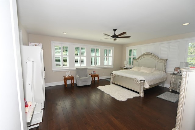 bedroom featuring multiple windows, ceiling fan, and dark hardwood / wood-style floors