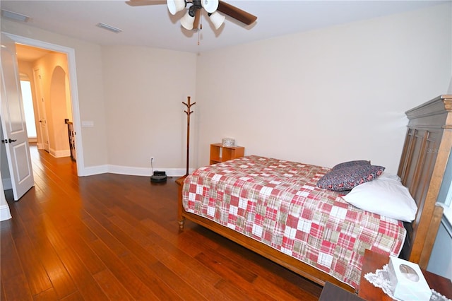 bedroom with dark hardwood / wood-style flooring and ceiling fan